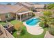 Aerial view of a backyard featuring a covered patio, turf, a pristine pool, and block fence at 346 E Red Mesa Trl, San Tan Valley, AZ 85143