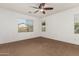 Bright, spacious bedroom with a ceiling fan and natural light from the large windows at 346 E Red Mesa Trl, San Tan Valley, AZ 85143