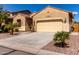 Home exterior features desert landscaping, a tile roof, and a two-car garage at 346 E Red Mesa Trl, San Tan Valley, AZ 85143