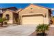 Home exterior features desert landscaping, a tile roof, and a two-car garage at 346 E Red Mesa Trl, San Tan Valley, AZ 85143