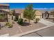 Beige single-story home with a two-car garage, tile roof, and xeriscaped yard with mature landscaping at 346 E Red Mesa Trl, San Tan Valley, AZ 85143