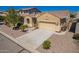 Beige single-story home with a tile roof, desert landscaping, and a two car garage at 346 E Red Mesa Trl, San Tan Valley, AZ 85143