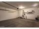 Well-lit garage with a concrete floor, water softener, storage shelf, and garage door opener at 346 E Red Mesa Trl, San Tan Valley, AZ 85143