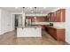 Spacious kitchen featuring a granite island, stainless steel appliances, and tile backsplash at 346 E Red Mesa Trl, San Tan Valley, AZ 85143