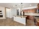 Spacious kitchen featuring a granite island, stainless steel appliances, and tile backsplash at 346 E Red Mesa Trl, San Tan Valley, AZ 85143