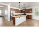 Spacious kitchen featuring a granite island, stainless steel appliances, and tile backsplash at 346 E Red Mesa Trl, San Tan Valley, AZ 85143