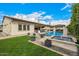 Beautiful backyard with a pristine pool, elegant water features, a well-manicured lawn, and inviting lounge areas at 3483 E Bloomfield Pkwy, Gilbert, AZ 85296
