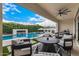Lush backyard featuring a pool, fireplace, and ample patio seating with a ceiling fan at 3483 E Bloomfield Pkwy, Gilbert, AZ 85296