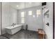 Modern bath with subway tile, glass enclosure, separate tub and shower, and dark tile floor at 3483 E Bloomfield Pkwy, Gilbert, AZ 85296