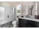 Modern bathroom featuring a subway tile shower, black and white patterned flooring, and vanity with white countertop at 3483 E Bloomfield Pkwy, Gilbert, AZ 85296