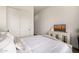 Bedroom with a decorative TV console and an upholstered bed with matching pillows at 3483 E Bloomfield Pkwy, Gilbert, AZ 85296