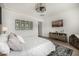 Comfortable bedroom with decorative ceiling fan, TV, modern decor, and wood-look floors at 3483 E Bloomfield Pkwy, Gilbert, AZ 85296