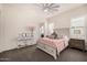 Comfortable bedroom with ceiling fan, shuttered window, pink decor, and carpet flooring at 3483 E Bloomfield Pkwy, Gilbert, AZ 85296