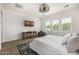Comfortable bedroom features wood-look floors, a decorative ceiling fan, and window with plantation shutters at 3483 E Bloomfield Pkwy, Gilbert, AZ 85296