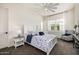Well-lit bedroom boasts a white bed frame, ceiling fan, and a neutral wall at 3483 E Bloomfield Pkwy, Gilbert, AZ 85296
