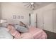 Bedroom showcasing a light pink comforter, a ceiling fan, and neutral paint at 3483 E Bloomfield Pkwy, Gilbert, AZ 85296