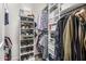 Organized walk-in closet with built-in shelves and ample storage space for clothing and shoes at 3483 E Bloomfield Pkwy, Gilbert, AZ 85296