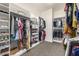 Spacious walk-in closet features multiple storage shelves and hanging racks for clothing at 3483 E Bloomfield Pkwy, Gilbert, AZ 85296