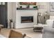 Modern fireplace with a white brick surround and a wooden mantle shelf at 3483 E Bloomfield Pkwy, Gilbert, AZ 85296