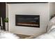 A close-up of a modern electric fireplace with a white brick surround at 3483 E Bloomfield Pkwy, Gilbert, AZ 85296