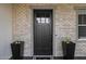 Elegant front door with brick surround and decorative planters at 3483 E Bloomfield Pkwy, Gilbert, AZ 85296