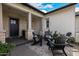 Inviting front porch with stylish furniture, decorative plants, and brick accents at 3483 E Bloomfield Pkwy, Gilbert, AZ 85296