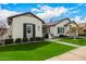 Charming home with lush lawn, landscaped garden beds, and stone walkway at 3483 E Bloomfield Pkwy, Gilbert, AZ 85296