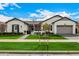 Beautiful single-story home featuring a lush green lawn, charming landscaping, and a convenient two-car garage at 3483 E Bloomfield Pkwy, Gilbert, AZ 85296