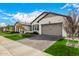 Attractive home featuring manicured landscaping, a brick driveway, and a two-car garage at 3483 E Bloomfield Pkwy, Gilbert, AZ 85296