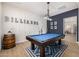 Game room with a blue felt billiards table, decorative wood wall, and rustic barrel at 3483 E Bloomfield Pkwy, Gilbert, AZ 85296