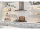 Modern kitchen with floating shelves and white cabinets at 3483 E Bloomfield Pkwy, Gilbert, AZ 85296