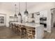 Spacious kitchen island with seating, modern appliances, and stylish pendant lighting at 3483 E Bloomfield Pkwy, Gilbert, AZ 85296