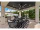 Inviting outdoor dining area featuring a built-in grill, ceiling fan, and stylish black table setting at 3483 E Bloomfield Pkwy, Gilbert, AZ 85296