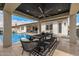 Relaxing outdoor dining space by the pool, featuring a covered patio with a fan and comfortable seating at 3483 E Bloomfield Pkwy, Gilbert, AZ 85296