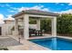 Poolside pavilion with a dining area and built-in grill, perfect for entertaining and enjoying outdoor meals at 3483 E Bloomfield Pkwy, Gilbert, AZ 85296