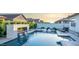 Luxurious pool area featuring a fire element, spa, and sun loungers, perfect for relaxation and entertainment at 3483 E Bloomfield Pkwy, Gilbert, AZ 85296