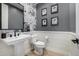 Stylish powder room with modern fixtures and floral accent wall at 3483 E Bloomfield Pkwy, Gilbert, AZ 85296