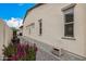 This side yard features flowers in planters, a rock bed and a paver sidewalk at 3483 E Bloomfield Pkwy, Gilbert, AZ 85296