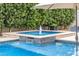 Charming water feature with a fountain and lush greenery, creating a serene and inviting poolside retreat at 3483 E Bloomfield Pkwy, Gilbert, AZ 85296