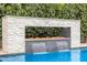 Elegant water feature with a fire pit, cascading waterfalls, and stone accents by the sparkling swimming pool at 3483 E Bloomfield Pkwy, Gilbert, AZ 85296