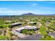 Expansive desert estate featuring multiple buildings, neutral color scheme, mature landscaping and mountain views at 35348 N 87Th St, Scottsdale, AZ 85266