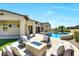 Entertainer's backyard with a fire pit, seating, desert landscaping, and sparkling pool and spa at 35348 N 87Th St, Scottsdale, AZ 85266