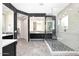 Modern bathroom featuring walk-in shower, hexagon tile floor, and stylish black and white design at 35348 N 87Th St, Scottsdale, AZ 85266