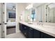Well-lit bathroom with double sinks, vanity, and access to the bedroom at 35348 N 87Th St, Scottsdale, AZ 85266