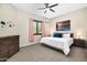 Cozy bedroom featuring a ceiling fan, dresser, natural light, and comfortable furnishings at 35348 N 87Th St, Scottsdale, AZ 85266