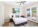 Cozy bedroom featuring a king-size bed, modern décor, ceiling fan and access to an outdoor space at 35348 N 87Th St, Scottsdale, AZ 85266