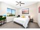 Comfortable bedroom with large windows, carpeted floors, ceiling fan, and tasteful decorations at 35348 N 87Th St, Scottsdale, AZ 85266