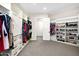Spacious walk-in closet with custom shelving, ample storage, and a neutral color palette at 35348 N 87Th St, Scottsdale, AZ 85266