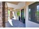 Covered front porch adorned with planters and a modern door, complementing the stone exterior at 35348 N 87Th St, Scottsdale, AZ 85266