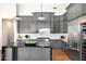 Spacious kitchen featuring gray cabinets, stainless steel appliances, and a center island with bar stool seating at 35348 N 87Th St, Scottsdale, AZ 85266